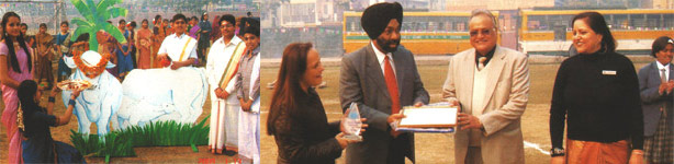 Matoo Pongal worshipping the Cow AND Mr. Agarwal, The Chairman presenting the cheque to Mr. Harpreet Singh, SOS